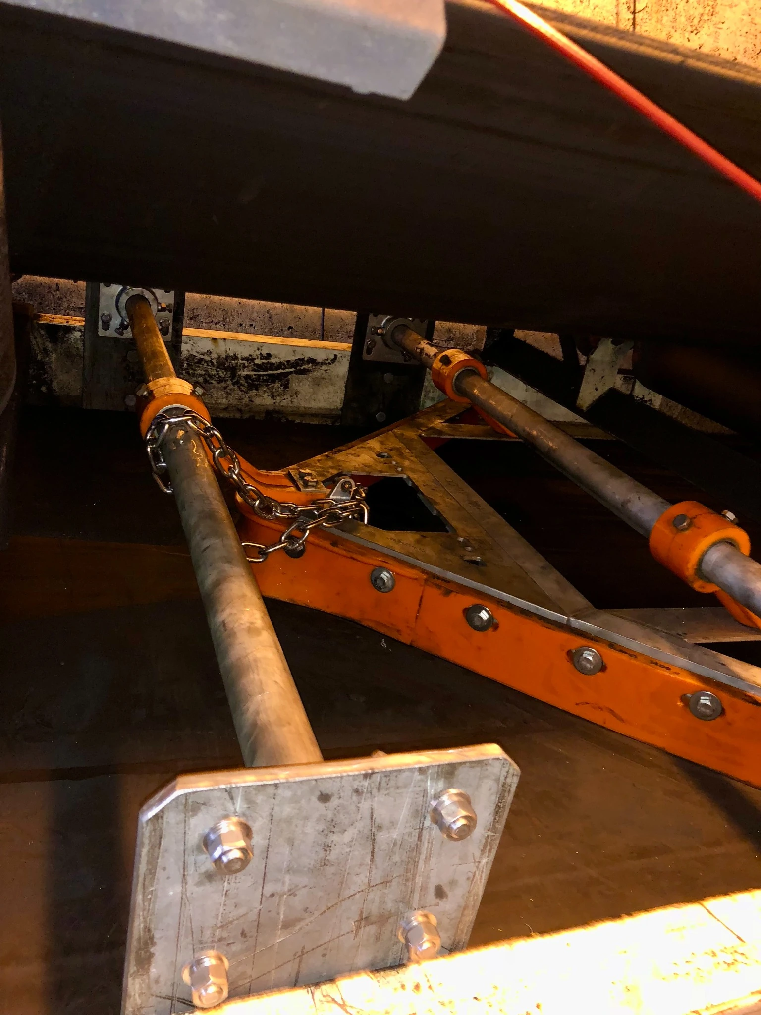 V-plough installation showing support poles, mounting plates and restraint chain.